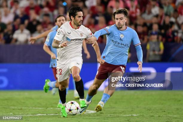 Sevilla's Spanish midfielder Isco fights for the ball with Manchester City's English midfielder Jack Grealish during the UEFA Champions League Group...