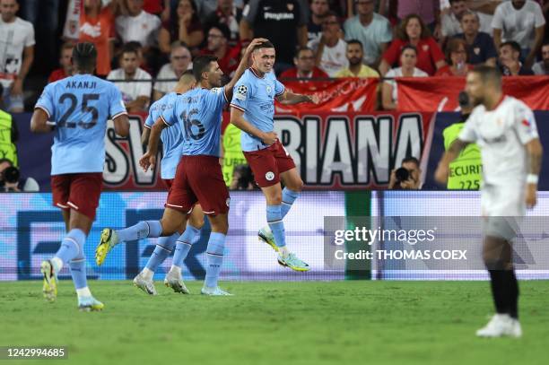 Manchester City's English midfielder Phil Foden celebrates with teammates after scoring his team's second goal during the UEFA Champions League Group...