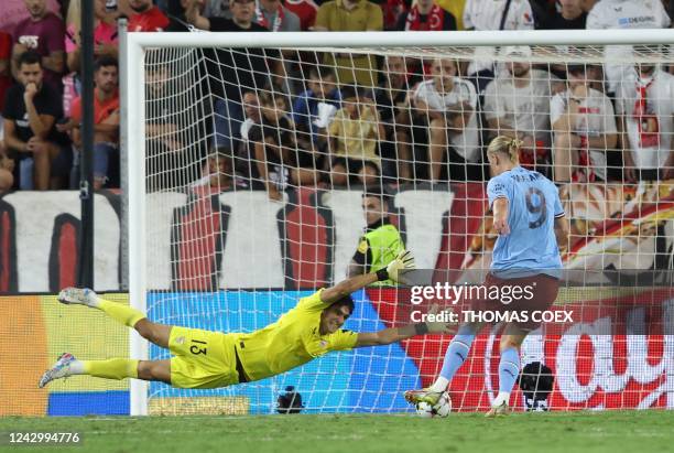 Manchester City's Norwegian striker Erling Haaland scores his team's third goal in spite of Sevilla's Moroccan goalkeeper Yassine Bounou "Bono"...