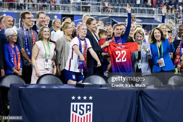 Members of U.S. Soccer and the U.S. Women's National Team Players Association hold up an Equal Pay jersey after signing a collective bargaining...