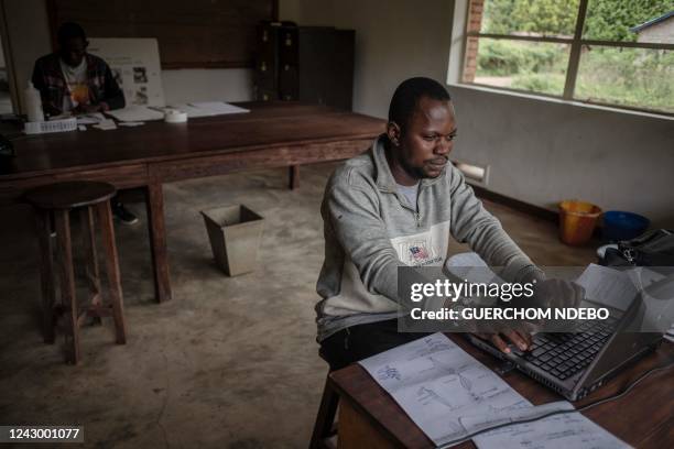 Robert Lokombe a forestry engineer, prepares herbarium labels for better classification and referencing during the digitisation at the herbarium in...