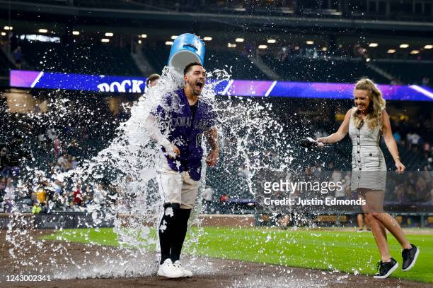 Randal Grichuk of the Colorado Rockies is doused with water by Charlie Blackmon after hitting a walk-off three run home run to defeat the Milwaukee...