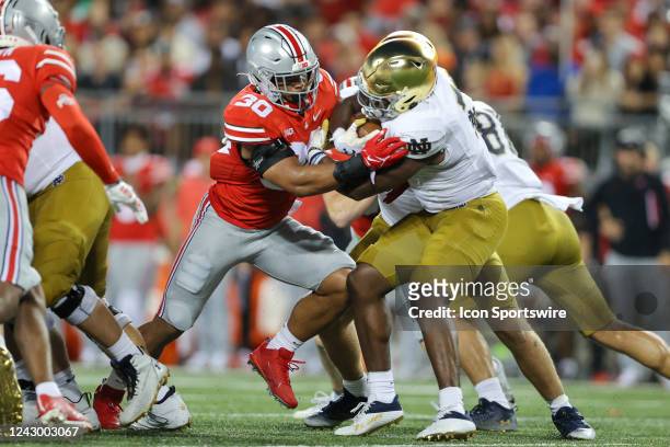 Ohio State Buckeyes linebacker Cody Simon attempts to tackle Notre Dame Fighting Irish running back Audric Estime during the first quarter of the...