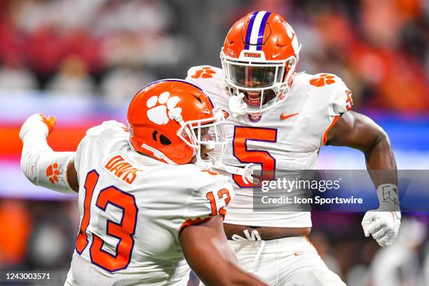 Clemson defensive end K.J. Henry and defensive tackle Tyler Davis react after an interception during the Chick-Fil-A Kickoff Game between the Clemson...