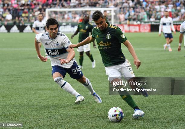 Portland Timbers defender Josecarlos Van Rankin controls the ball against Vancouver Whitecaps FC forward Brian White during a match between the...