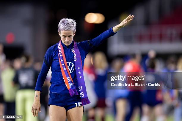 Megan Rapinoe of United States wears an Equal Pay scarf waves to fans after winning the friendly match against Nigeria and the watching the signing...