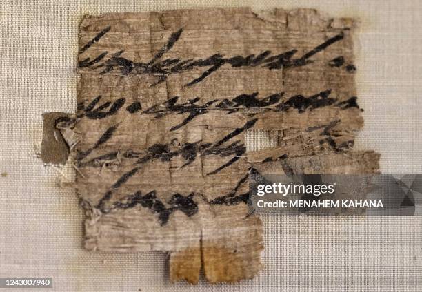 This picture taken on September 7, 2022 shows a view of a papyrus fragment presented by the Israel Antiquities Authority at its Dead Sea conservation...