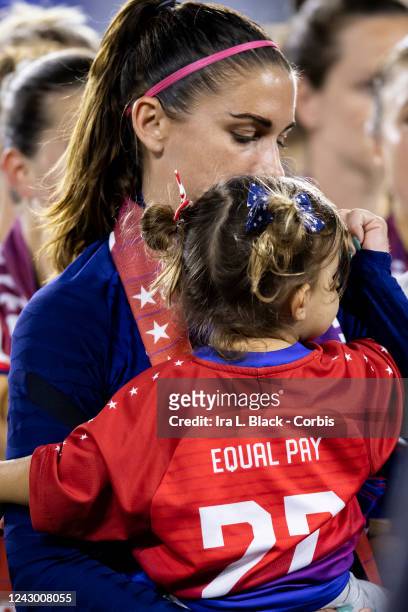 The daughter of Alex Morgan of United States wears a jersey that says Equal Pay 22 as they watch the signing of the historic collective bargaining...