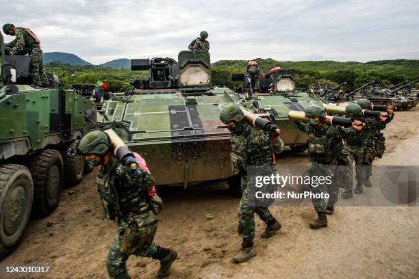 Taiwanese soldiers carrying artillery to tanks during the 2-day live-fire drill, amid intensifying threats military from China, in Pingtung county,...