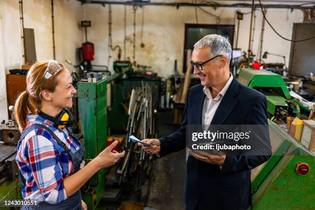 male supervisor evaluate work in factory - paying employees stock pictures, royalty-free photos & images