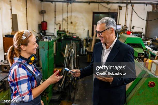 male supervisor evaluate work in factory - checked-suit stock pictures, royalty-free photos & images