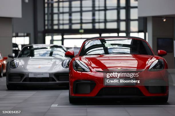 Porsche 718 Spyder luxury automobile, right, in the Porsche SE showroom in Dortmund, Germany, on Wednesday, Sept. 7 2022. Volkswagen AG is pushing...