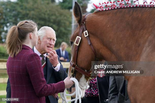 Britain's Prince Charles, Prince of Wales known as the Duke of Rothesay while in Scotland, and Patron of the Clydesdale Horse Society looks at police...