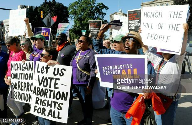 Pro choice supporters gather outside the Michigan State Capitol during a "Restore Roe" rally in Lansing, on September 7, 2022. - Michigan's elections...