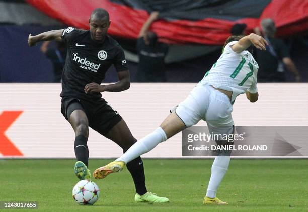 Frankfurt's French defender Evan N'Dicka and Sporting Lisbon's Portuguese forward Francisco Trincao vie for the ball during the UEFA Champions League...