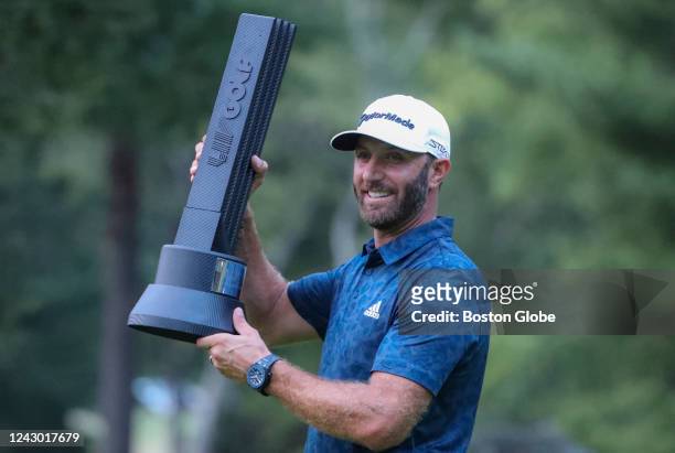 Bolton, MA Dustin Johnson holding the winners trophy after winning the LIV Golf Invitational Series Boston at The International Golf Course.