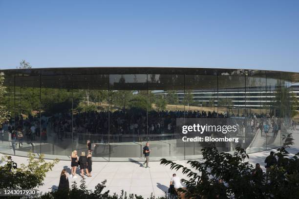 Attendees arrive at the Steve Jobs Theater ahead of an event at Apple Park campus in Cupertino, California, US, on Wednesday, Sept. 7, 2022. At a...
