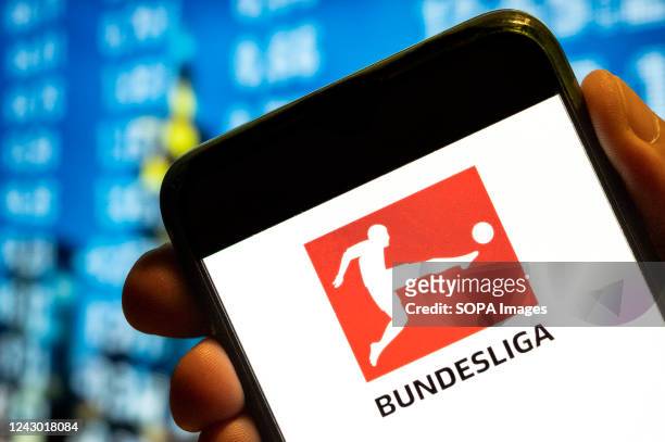 In this photo illustration, the German professional association football league Bundesliga logo is displayed on a smartphone screen.