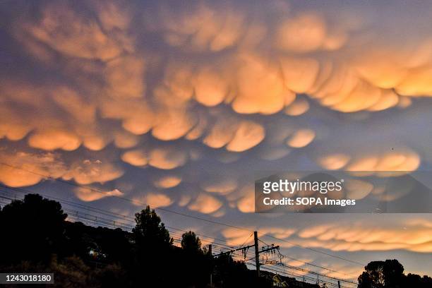 Mammatus clouds are seen in the sky at sunrise in Marseille.