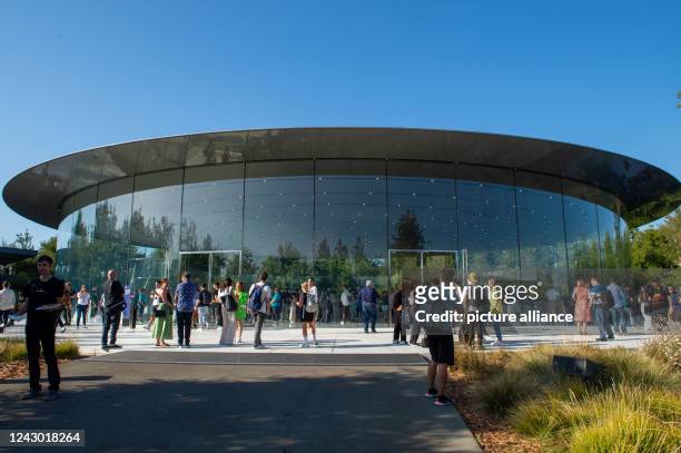 September 2022, US, Cupertino: Guests gather at the entrance to the Steve Jobs Theater on the grounds of Apple Park corporate headquarters ahead of...