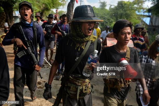 Anti-coup fighters escort protesters as they take part in a demonstration against the military coup in Sagaing, in the Sagaing Division of Myanmar on...