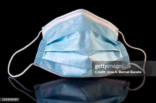 full frame of blue medical face mask on a black background. - nose mask stock pictures, royalty-free photos & images