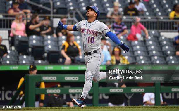 Eduardo Escobar of the New York Mets reacts as he rounds the bases after hitting a solo home run in the fourth inning during Game One of a...
