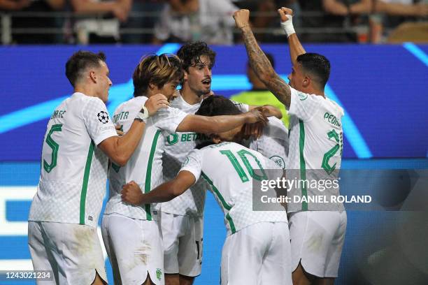 Sporting Lisbon's Portuguese forward Francisco Trincao celebrates scoring the 0-2 goal with his team-mates during the UEFA Champions League Group D...