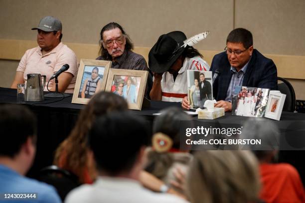 Mark Arcand , brother of James Smith Cree Nation stabbing victim Bonnie Burns, and Brian , husband of Bonnie, pause behind pictures of Bonnie during...