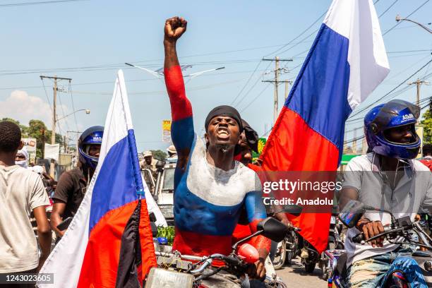 Demonstrators from different cities, holding banners and placards, gather to protest with demanding the removal of Prime Minister Ariel Henry as he...