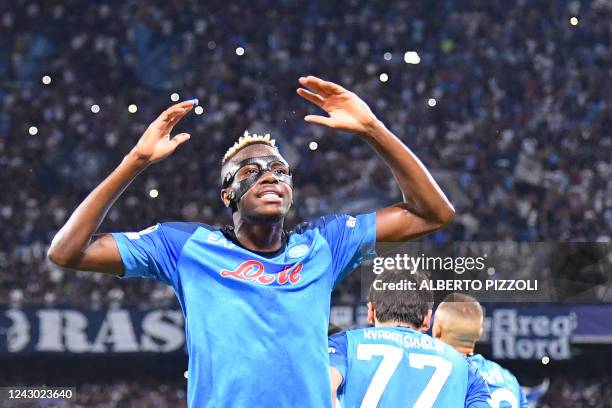 Napoli's Nigerian forward Victor Osimhen celebrates after his teams opened the score with a penalty kick during the UEFA Champions League Group A...