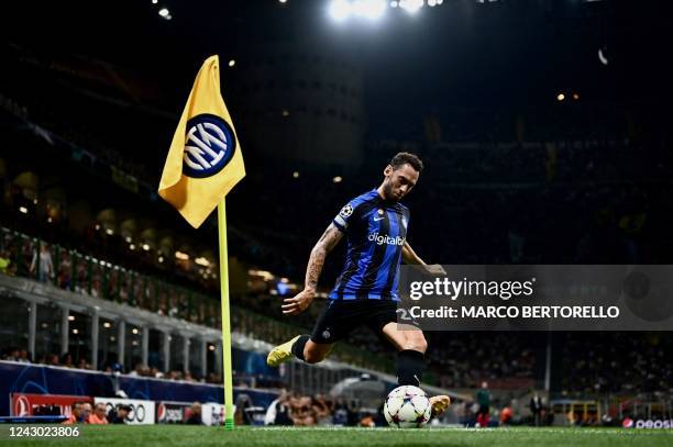 Inter Milan's Turkish midfielder Hakan Calhanoglu kicks a corner kick during the UEFA Champions League Group C football match between Inter Milan and...