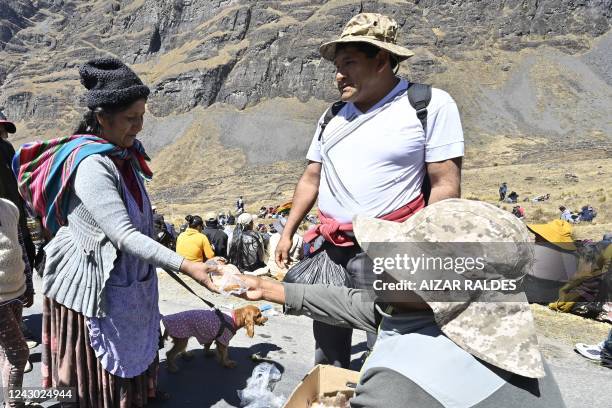 Coca leaf producer, opposer to the Government, receives bread during the fourth day of a march from Yungas valleys to La Paz, in Bolivia, on...