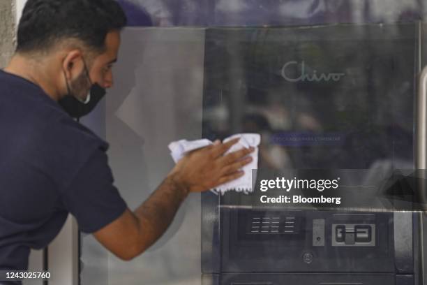 Worker prepares to open a government Chivo Bitcoin automated teller machine kiosk on the one-year anniversary of Bitcoin adoption in San Salvador, El...