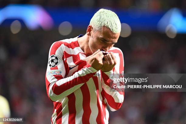 Atletico Madrid's French forward Antoine Griezmann celebrates after scoring during the UEFA Champions League Group B first-leg football match between...