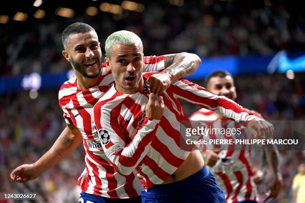 Atletico Madrid's French forward Antoine Griezmann celebrates with Atletico Madrid's Spanish defender Mario Hermoso after scoring during the UEFA...