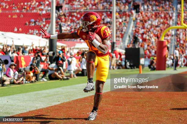 Trojans running back Raleek Brown runs the ball for a touchdown and strikes a Heisman pose during a college football game between the Rice Owls and...
