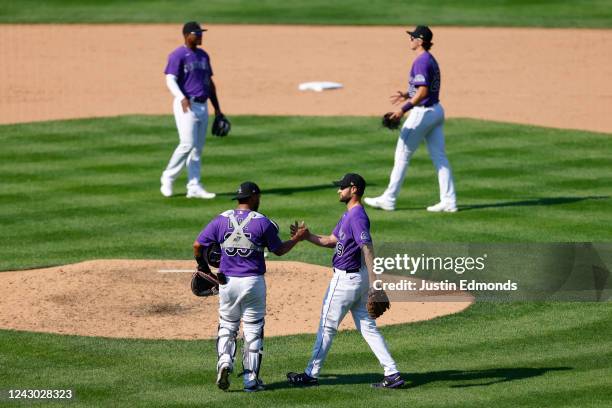 Elias Diaz, Jake Bird, Elehuris Montero and Michael Toglia of the Colorado Rockies celebrate their win against the Milwaukee Brewers at Coors Field...