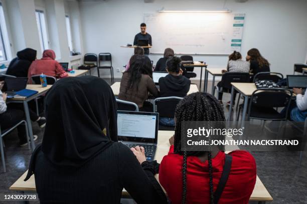 Students attend a class at the Drottning Blankas secondary school in Jarfalla, Sweden on August 29, 2022. - Thirty years after their introduction,...