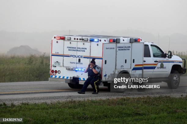 Royal Canadian Mounted Police officer covers her face at the scene where suspect Myles Sanderson was arrested, along Highway 11 near the town of...