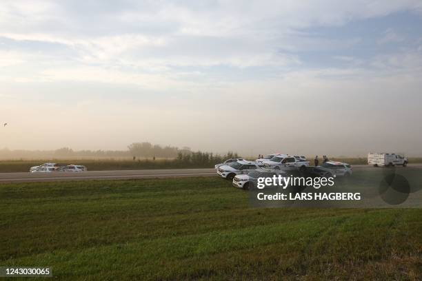 Royal Canadian Mounted Police vehicles are seen next to a pickup truck at the scene where suspect Myles Sanderson was arrested, along Highway 11 near...