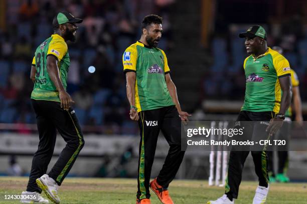 Mohammad Amir , Raymon Reifer and Rovman Powell of Jamaica Tallawahs celebrate the dismissal of Faf Du Plessis of Saint Lucia Kings during the Men's...