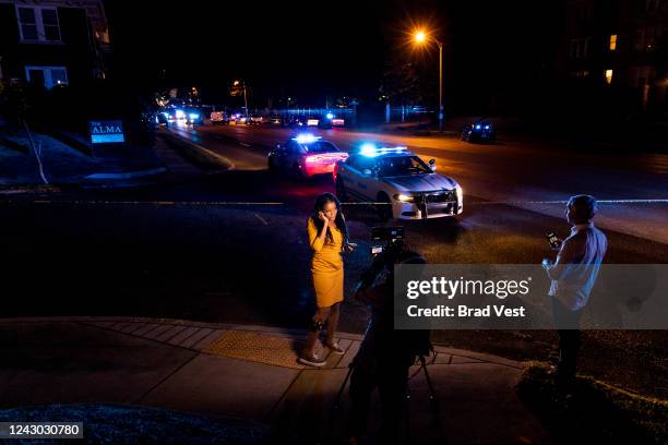 News crew reports as police investigate the scene of a reported carjacking reportedly connected to a series of shootings on September 7, 2022 in...