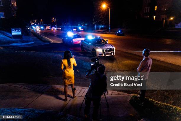 News crew reports as police investigate the scene of a reported carjacking reportedly connected to a series of shootings on September 7, 2022 in...