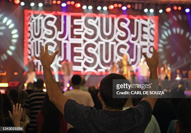 Churchgoers attend a ceremony at the Assembly of God evangelical church in Rio de Janeiro, Brazil, on August 23, 2022. - The approach between...