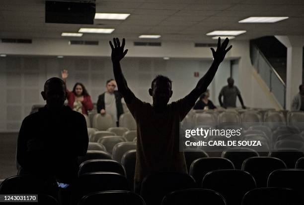 Churchgoers attend a ceremony at the Assembly of God evangelical church in Rio de Janeiro, Brazil, on August 23, 2022. - The approach between...