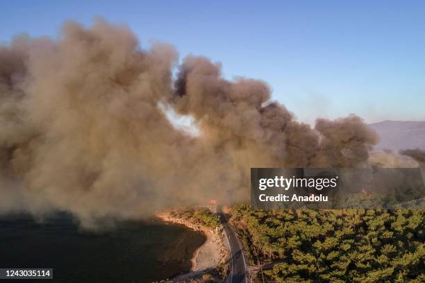 An aerial view of an active fire line, where smoke rises up from the wildfire that spreads to a neighborhood of the Silifke district, after it broke...