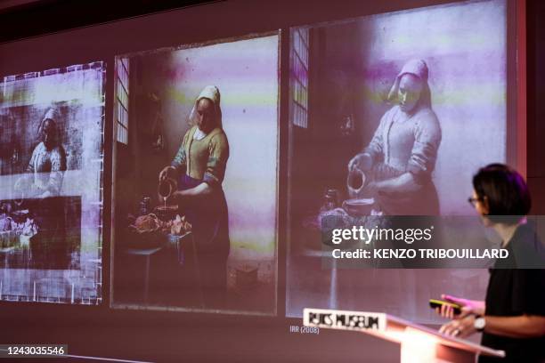 Annelies Van Loon, paintings conservator and chemist of the Rijksmuseum shows a detail on a screen projection of the painting the "Milkmaid" by...