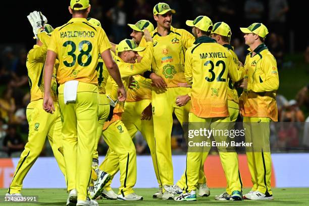 Steven Smith and the Australian team congratulate Adam Zampa after taking the wicket of Devon Conway during game two of the One Day International...