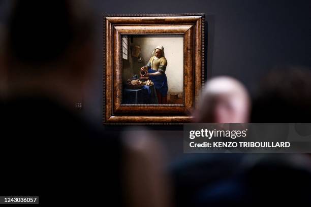 This photograph taken on September 8 shows the painting the "Milkmaid" by Johannes Vermeer during a press conference on new discoveries made on one...